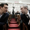 Greek Prime Minister Alexis Tsipras (L) talks with Deputy Minister of Sports Stavros Kontonis (R) at the parliament prior to deliver a speech to his parliamentary group in Athens, Greece on February 17, 2015.