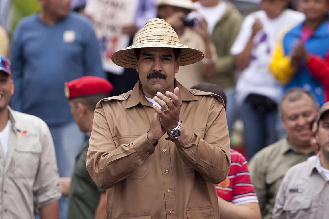 epa04101783 Venezuelan president Nicolas Maduro is seen during a farmer's demonstration summoned to support the Venezuelan government in Caracas, Venezuela, 26 February 2014. Maduro said that if the opposition was to take office they would "impose a dictatorship" and eliminate the festive days such as carnival and Holy Week. Venezuela remains the scene of marches and protests in support and against the government that began two weeks ago, in some cases demonstrations have turned violent leaving 150 injured, and 13 dead.  EPA/SANTI DONAIRE