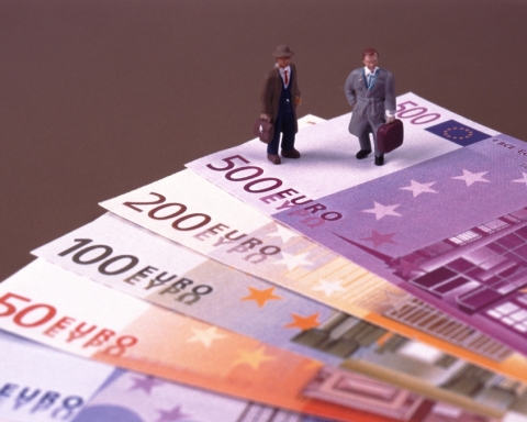 businessman standing on euro-notes