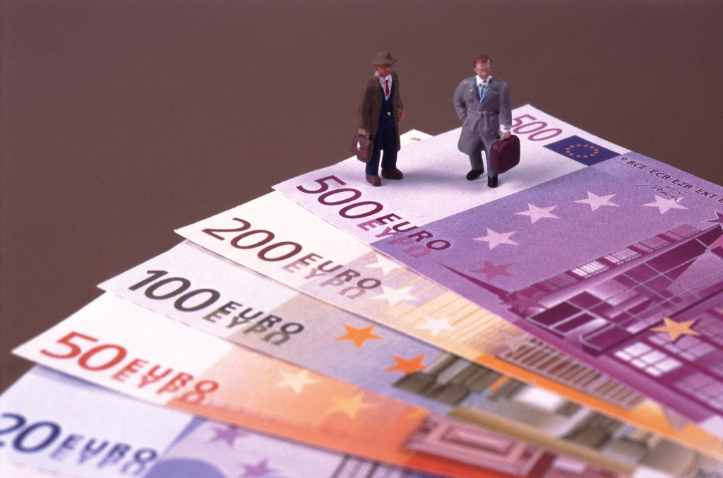 businessman standing on euro-notes