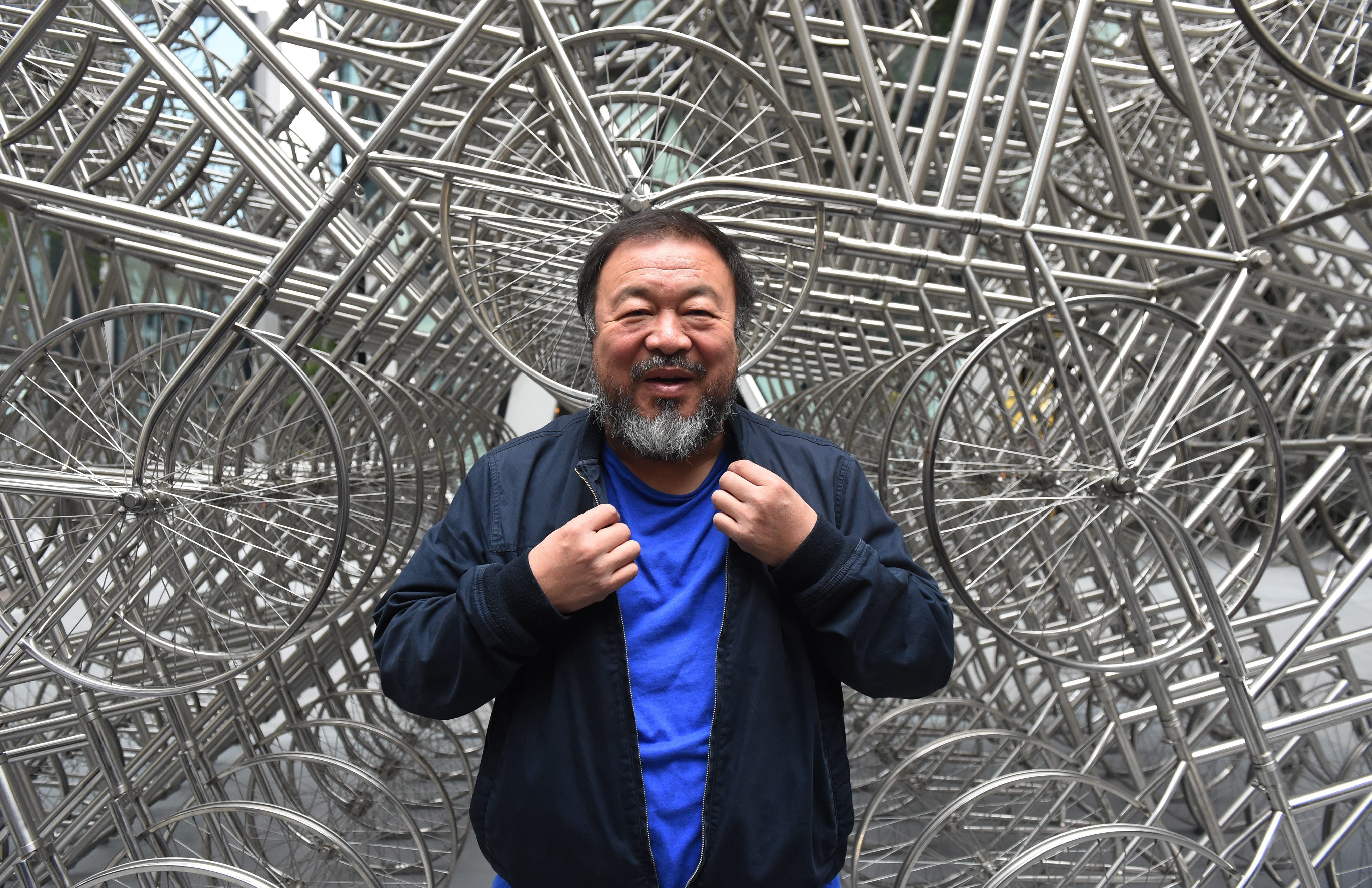 Ai WeiWei poses with new sculpture
